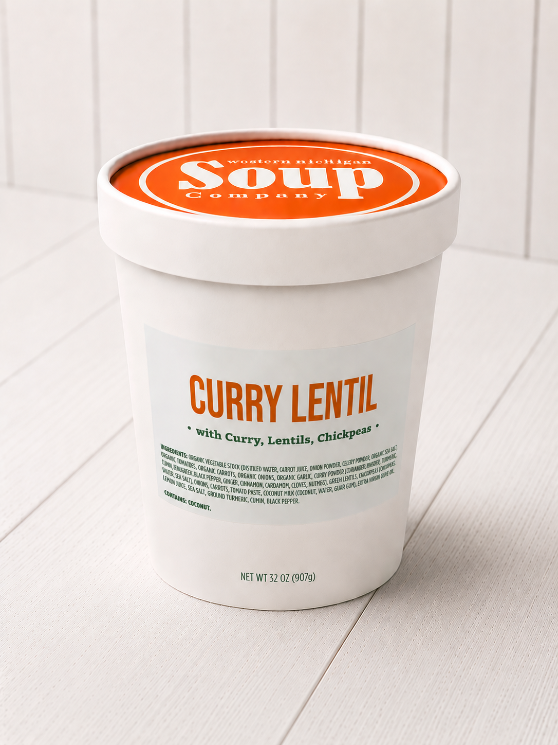 Container of Curry Lentil soup from the WISoup Company on a white surface.