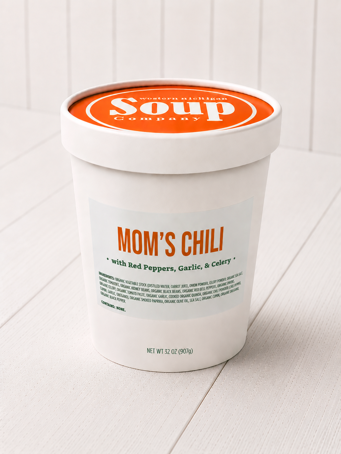 Container of 'Mom's Chili' soup from the 'WISoup Company' on a white surface.