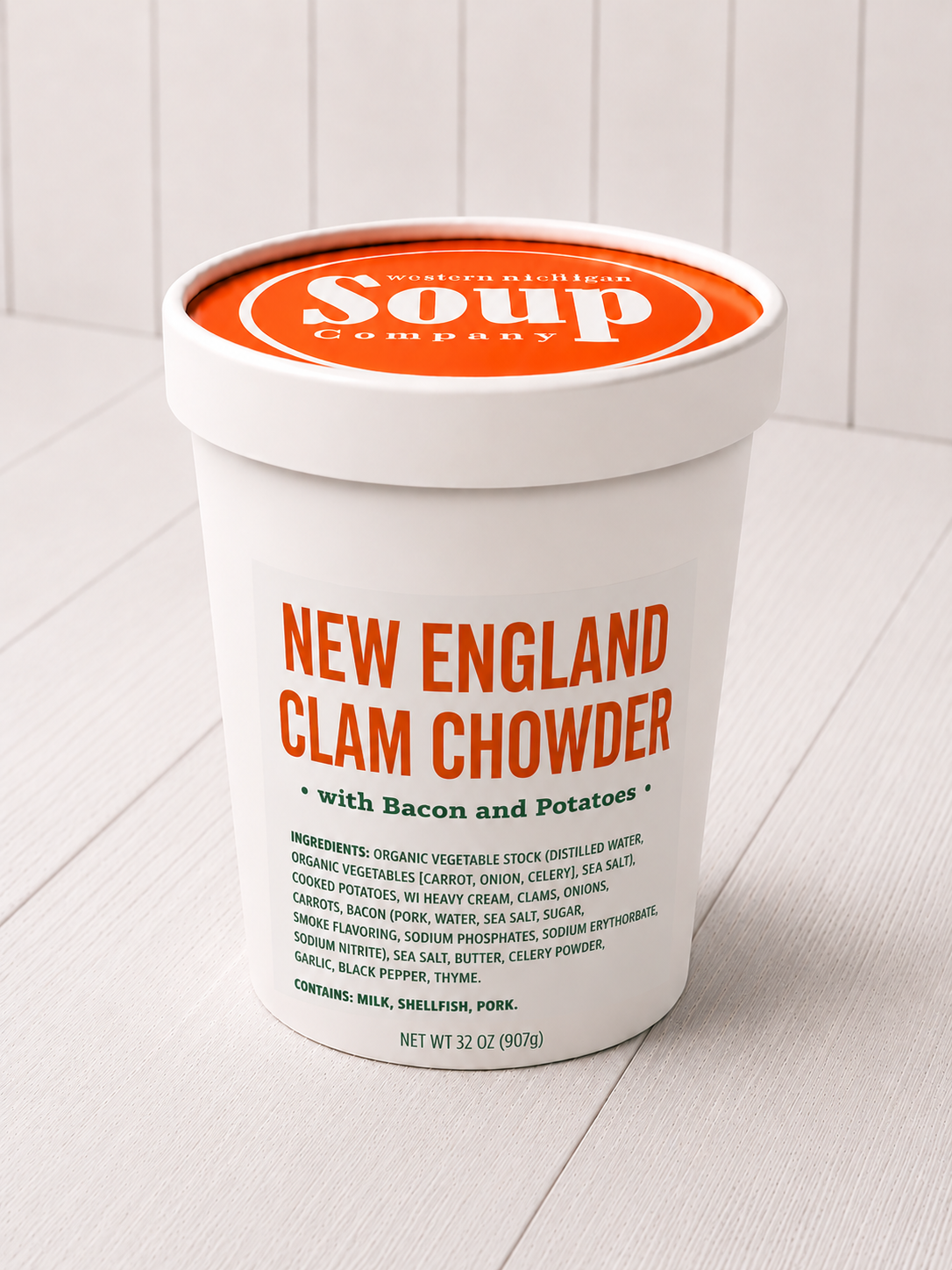Container of New England Clam Chowder with Bacon and Potatoes on a white background
