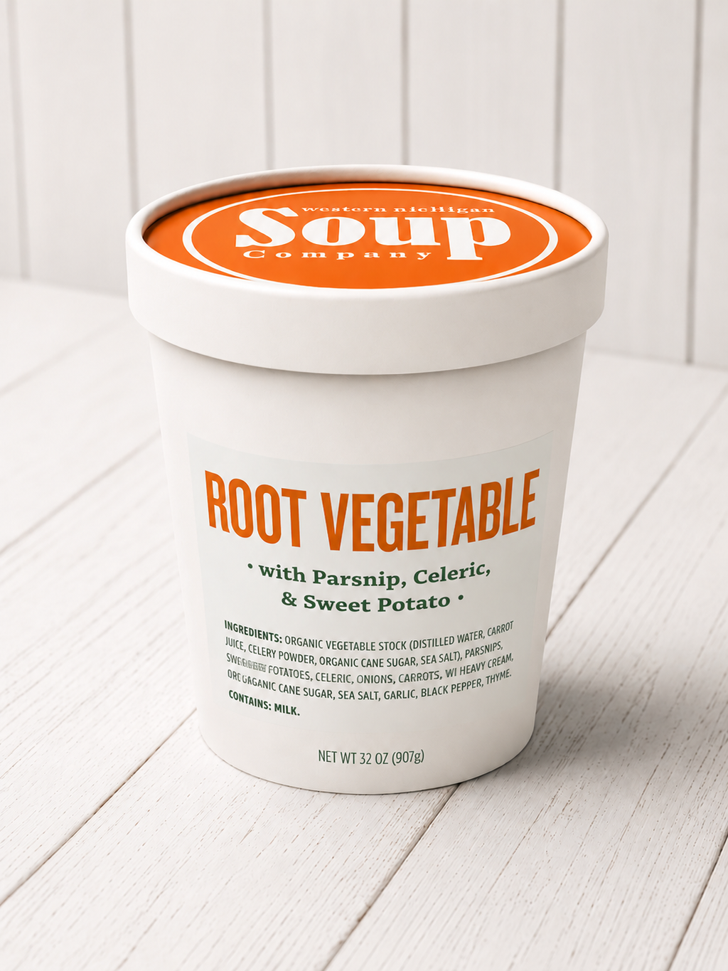 Container of root vegetable soup with 'WISoup Company' branding on a white wooden surface.