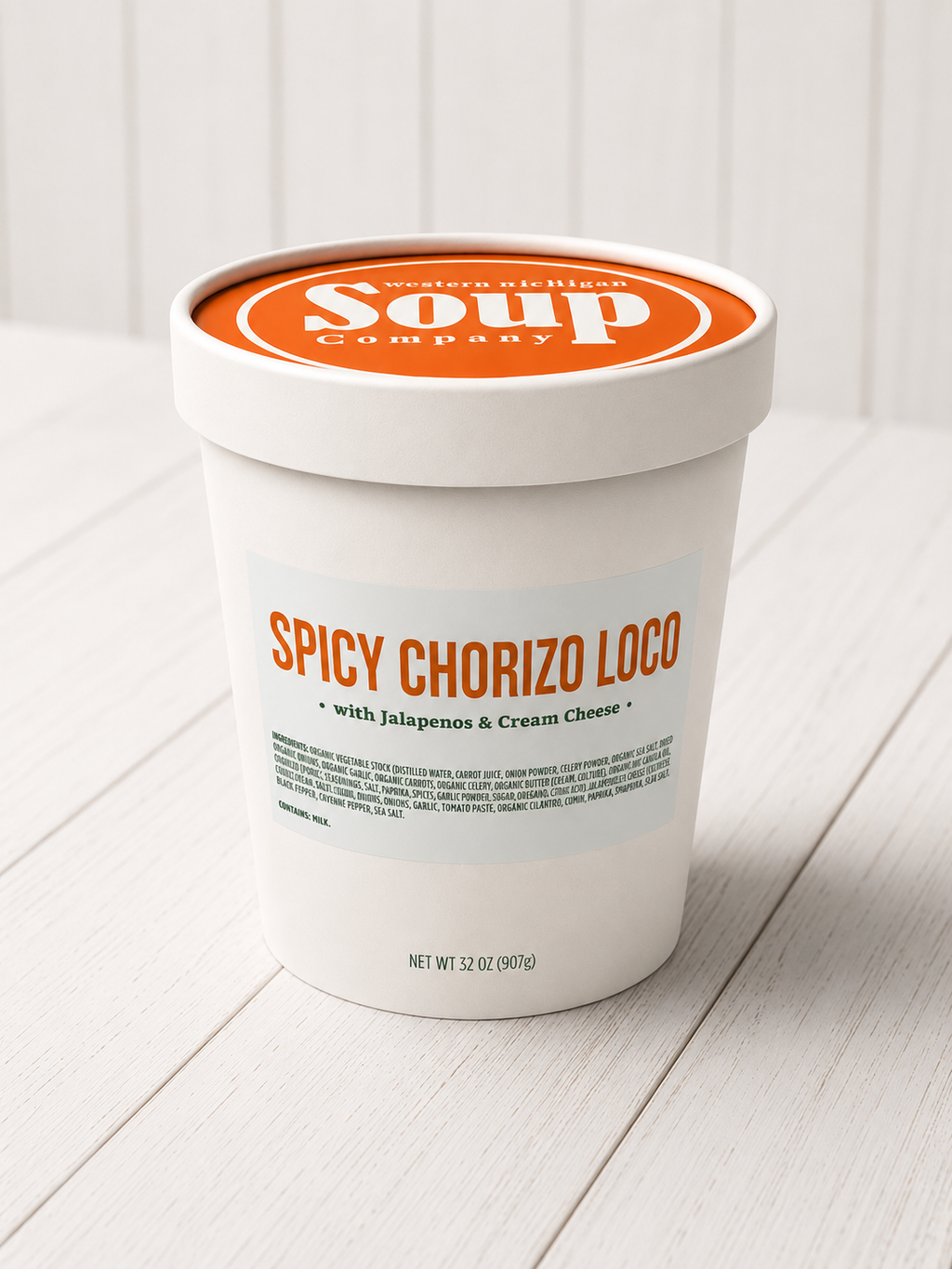 Container of Spicy Chorizo Loco soup from Soup Company on a white wooden surface