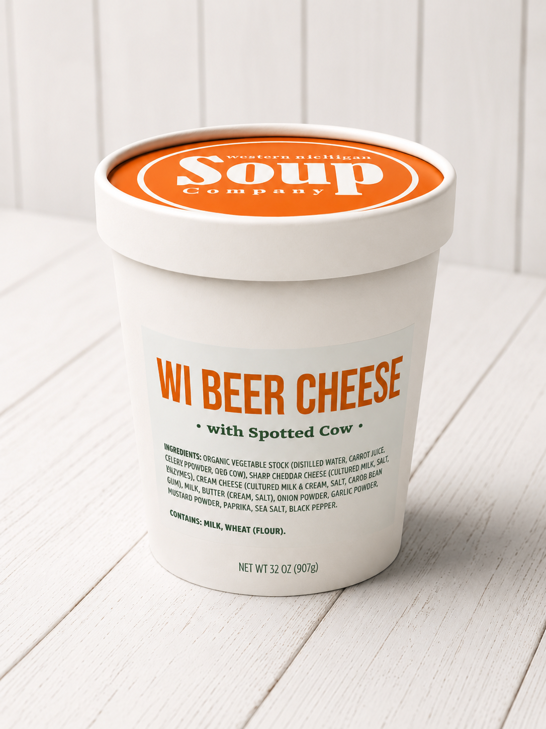 Container of WI Beer Cheese soup from WISoup Company on a white wooden surface.